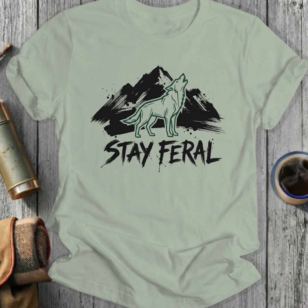 Green t-shirt with a wolf howling at mountains, text "STAY FER AL".
