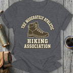 Dark grey t-shirt with a hiking boot and text reading Moderately Athletic Hiking Association.