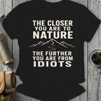 Black t-shirt with "The closer you are to nature, the further you are from idiots" text.