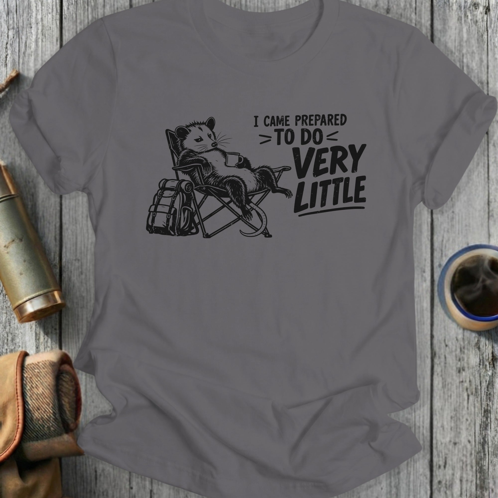 Opossum in lawn chair with mug and backpack, reads "I Came Prepared > To Do < Very Little".