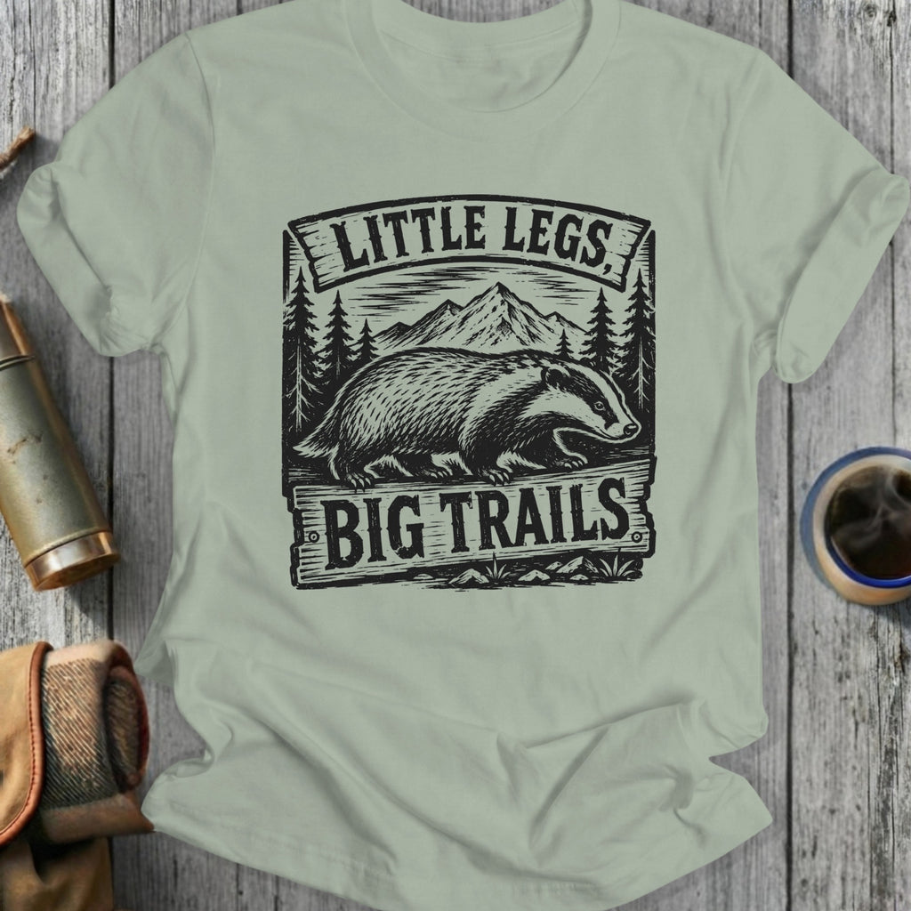 T-shirt with badger graphic and text "Little Legs Big Trails".