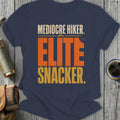 Mediocre Hiker. Elite Snacker. text on a navy t-shirt.