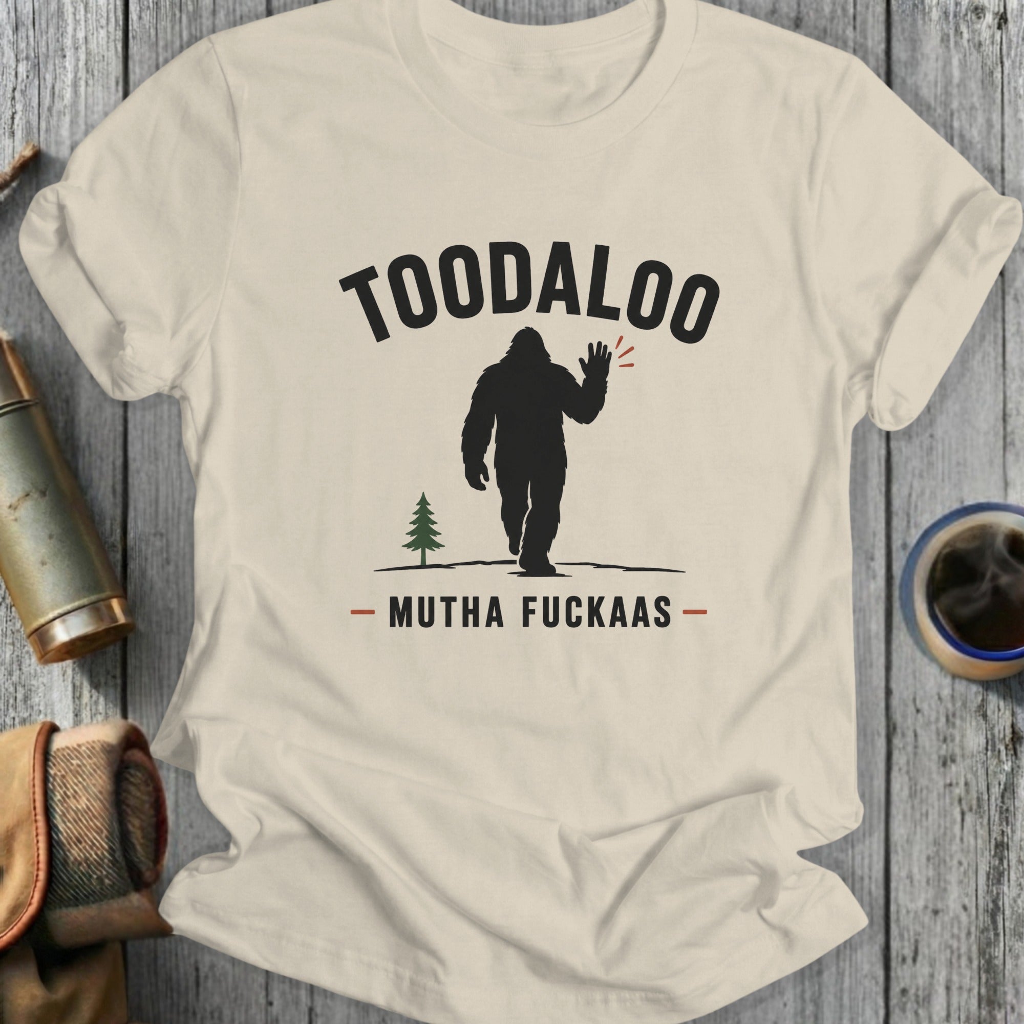Cream t-shirt with Bigfoot graphic, "TOODALOO" and "MUTHA FUCKAS" text.