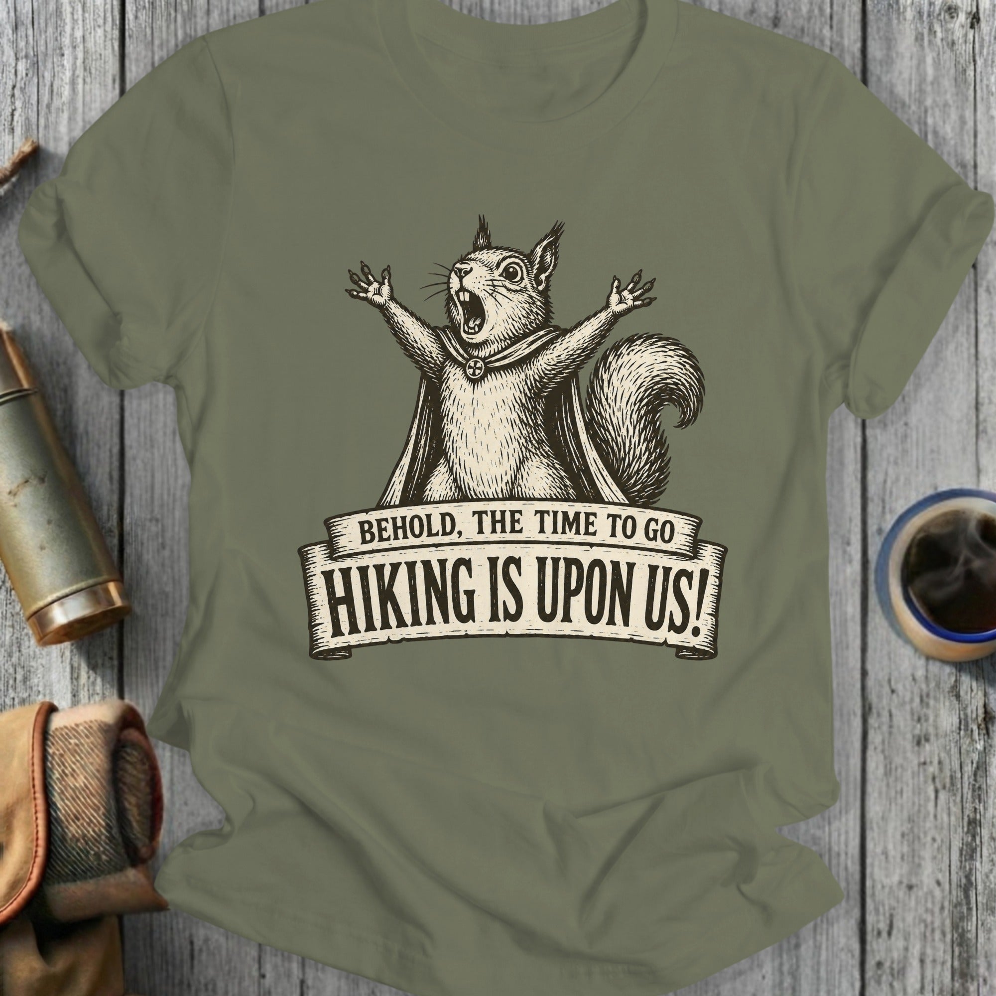 T-shirt graphic of a screaming squirrel in a cape with text "BEHOLD, THE TIME TO GO HIKING IS UPON US!"
