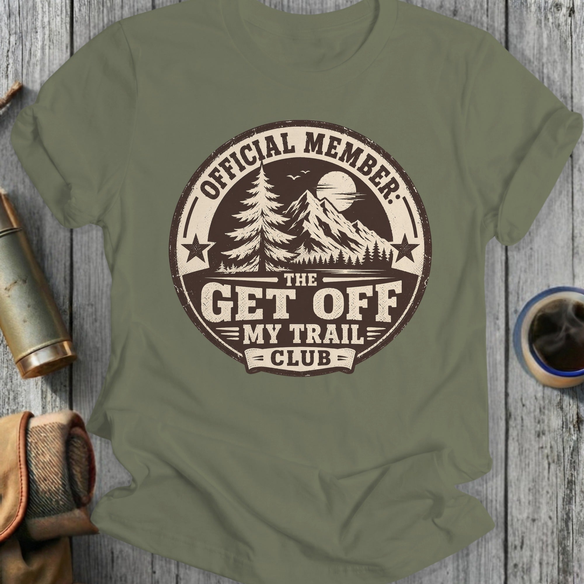 Olive green t-shirt with "Official Member Get Off My Trail Club" mountain graphic.