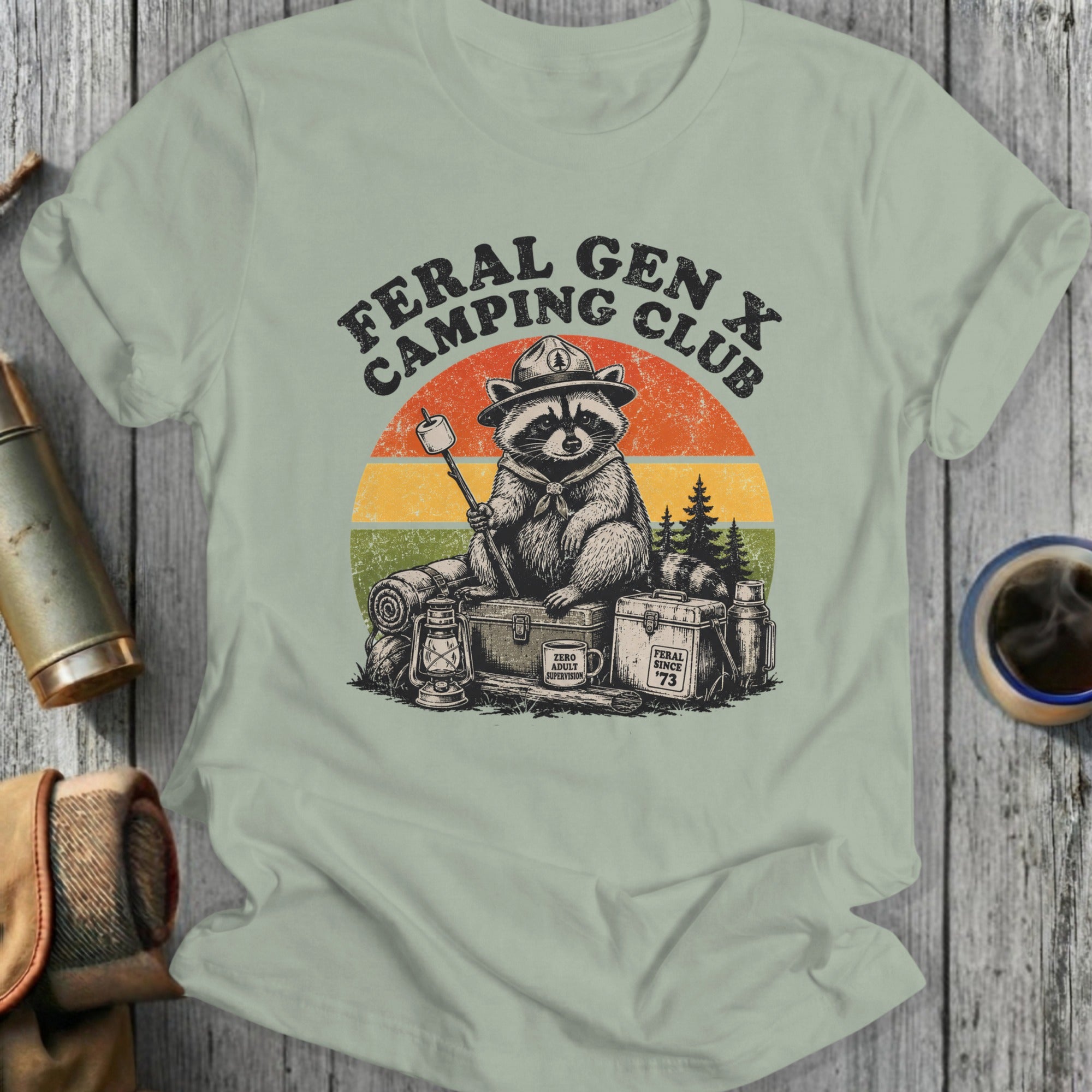Feral Gen X Camping Club raccoon with marshmallow, vintage sunset background.