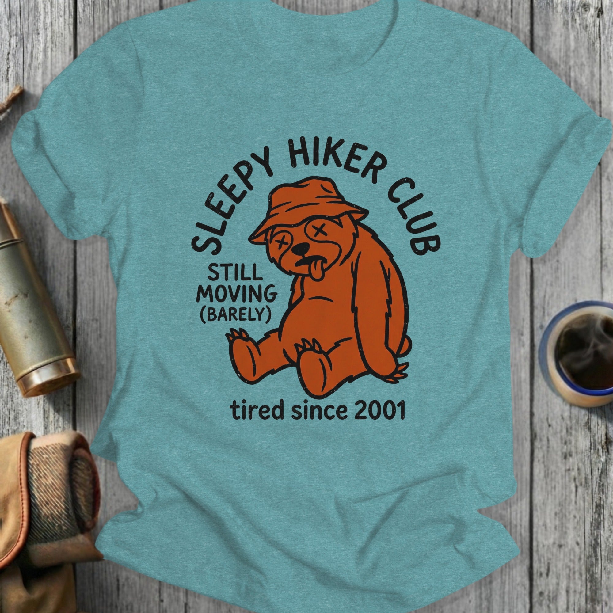 T-shirt graphic: sleepy hiker bear club logo, orange bear, text "tired since 2001".