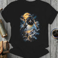 Black t-shirt with a graphic of a large penguin overlooking a smaller penguin with mountains and moon.
