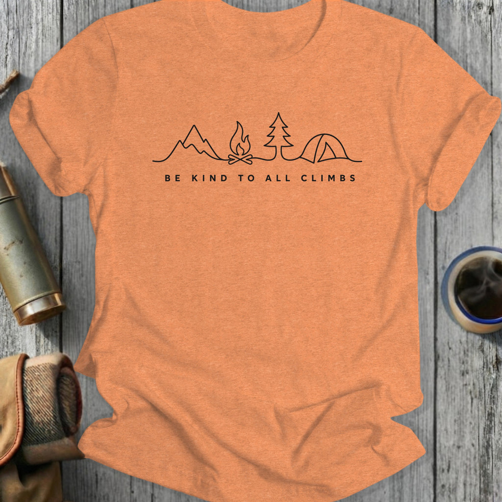 Orange t-shirt with line art of campfire, tree, and tent, and text "BE KIND TO ALL CLIMBS".