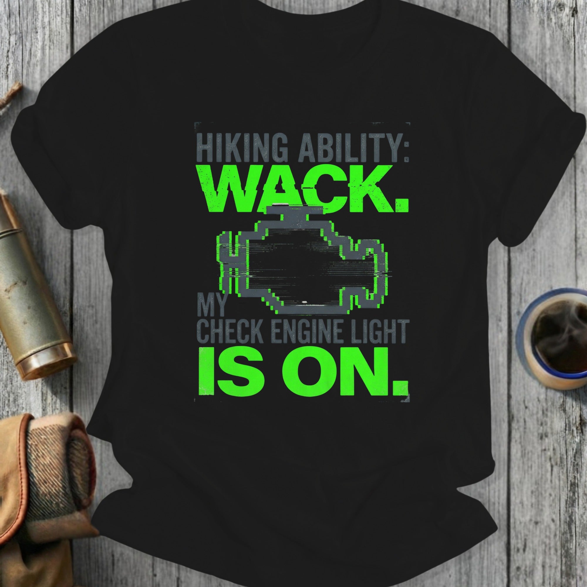 Black t-shirt with green text "Hiking Ability: WACK. My Check Engine Light is On."
