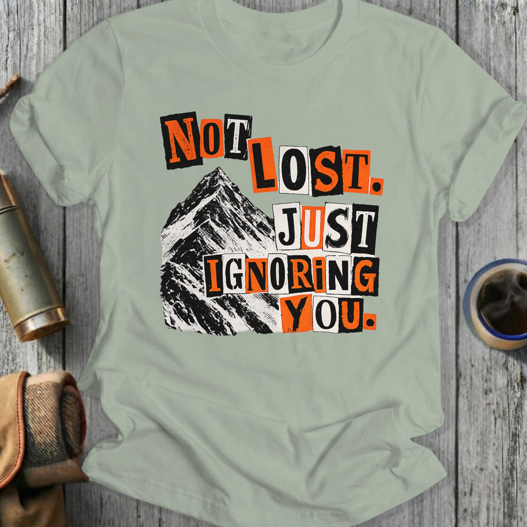 T-shirt with "Not lost. Just ignoring you." text over a mountain.