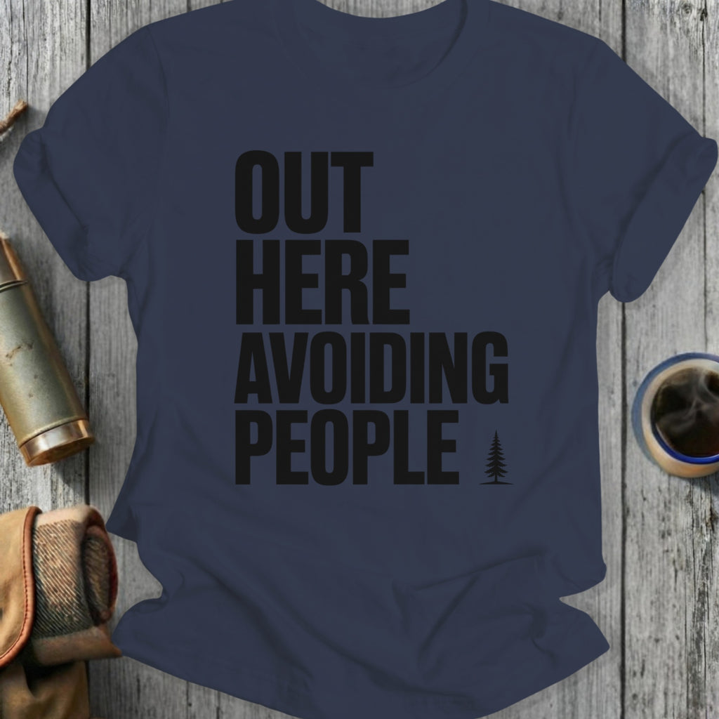 Navy t-shirt with black text "OUT HERE AVOIDING PEOPLE" and a small tree graphic.