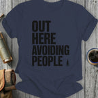 Navy t-shirt with black text "OUT HERE AVOIDING PEOPLE" and a small tree graphic.