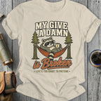 T-shirt graphic: raccoon in hammock with coffee, text "My Give A Damn is Broken".