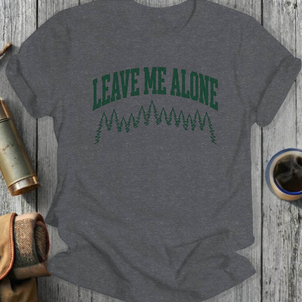 Dark grey t-shirt with "LEAVE ME ALONE" in green forest graphic.