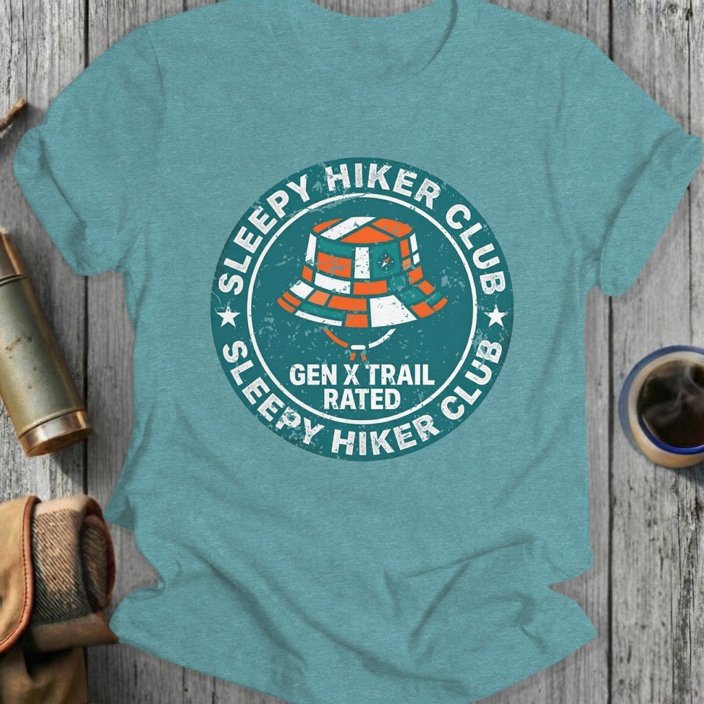 Sleepy Hiker Club Gen X Trail Rated circular logo on a teal t-shirt.