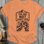 Orange t-shirt with mountain sign that reads "You Are Not Almost There".