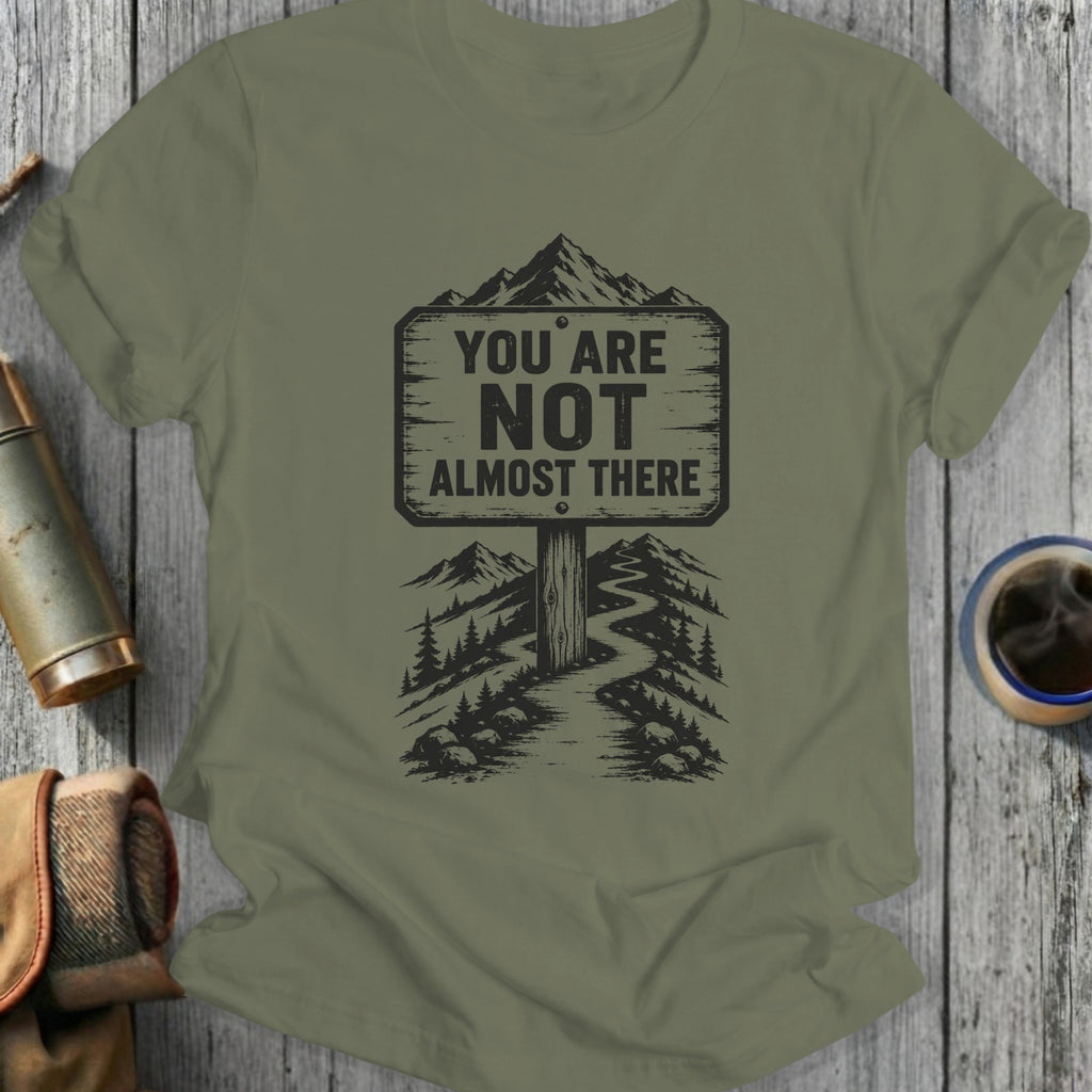 T-shirt with "YOU ARE NOT ALMOST THERE" text on a mountain road sign.