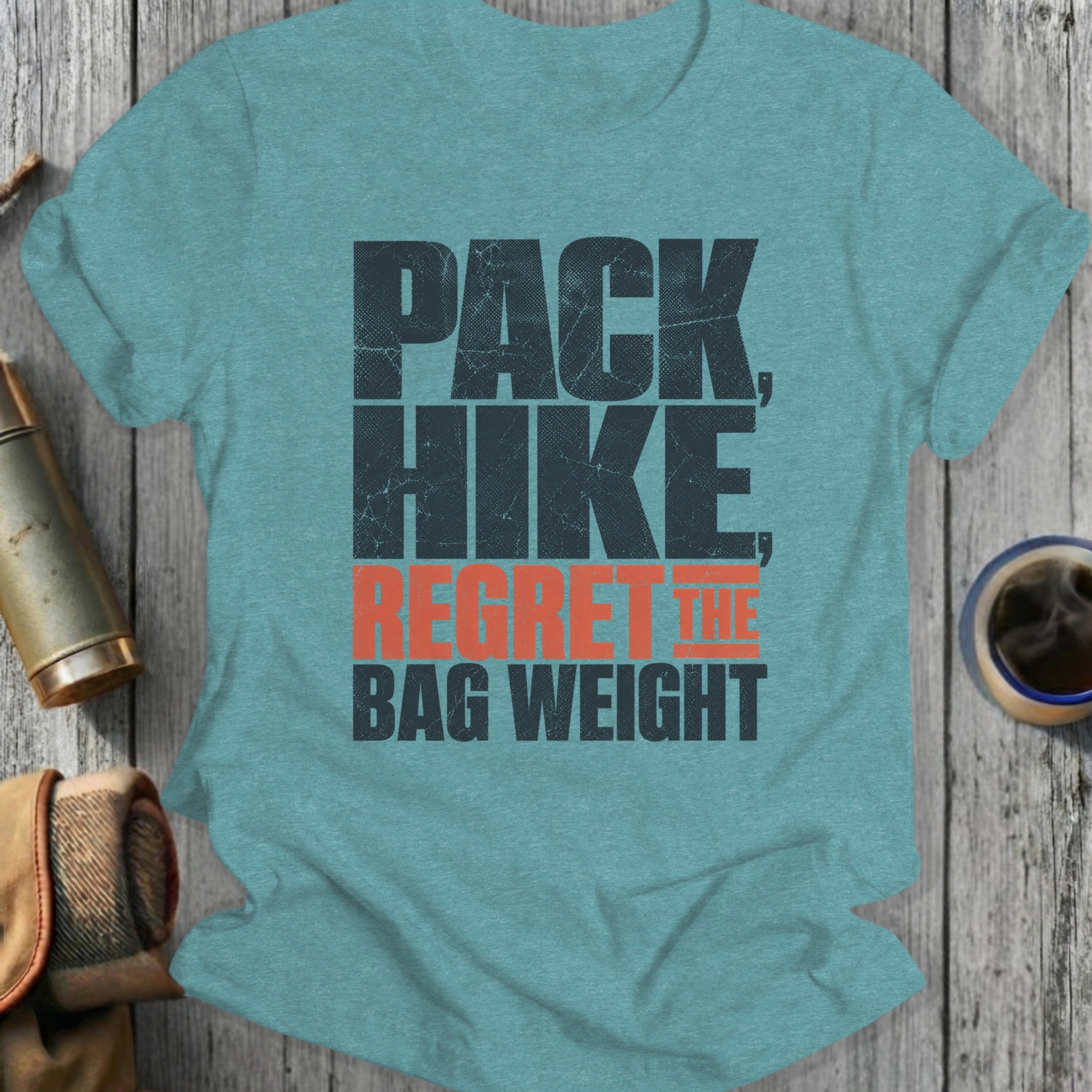 Pack, Hike, Regret the Bag Weight text on a teal t-shirt.