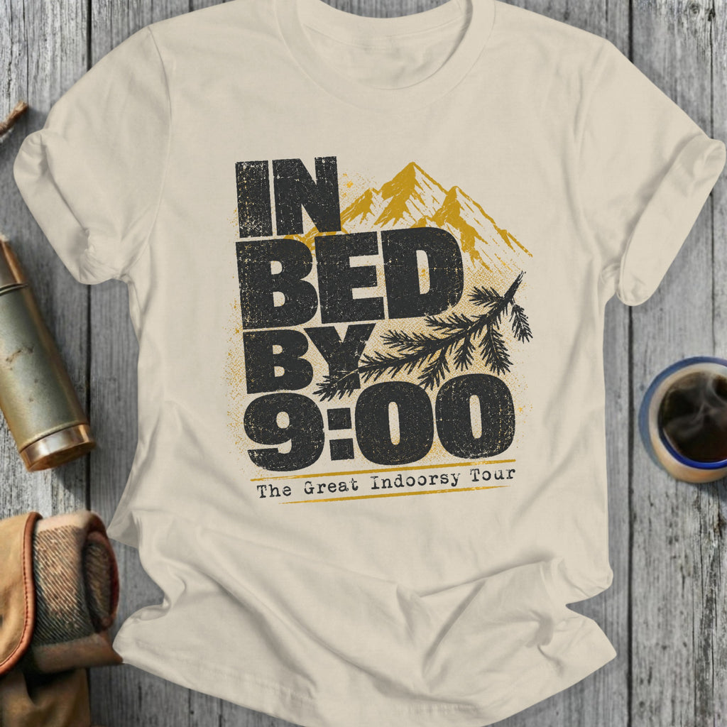 Cream t-shirt with distressed text and mountain graphic that reads "IN BED BY 9:00 The Great Indoorsy Tour."