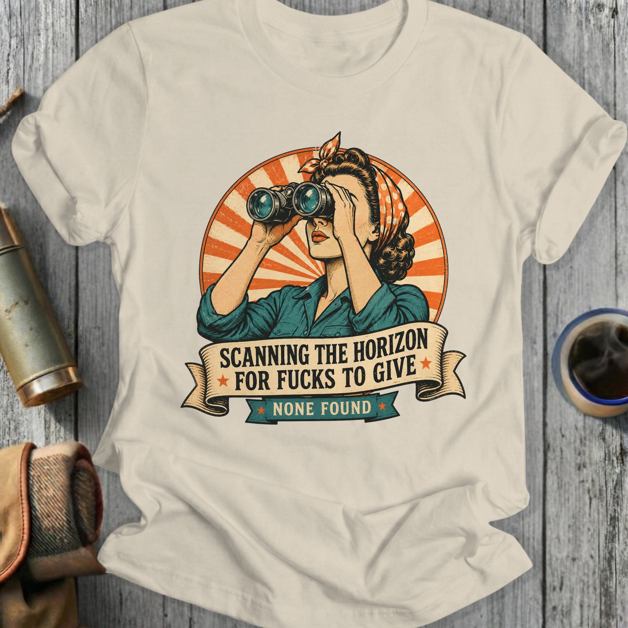 Woman in bandana looks through binoculars, text reads "Scanning the horizon for fucks to give, none found."