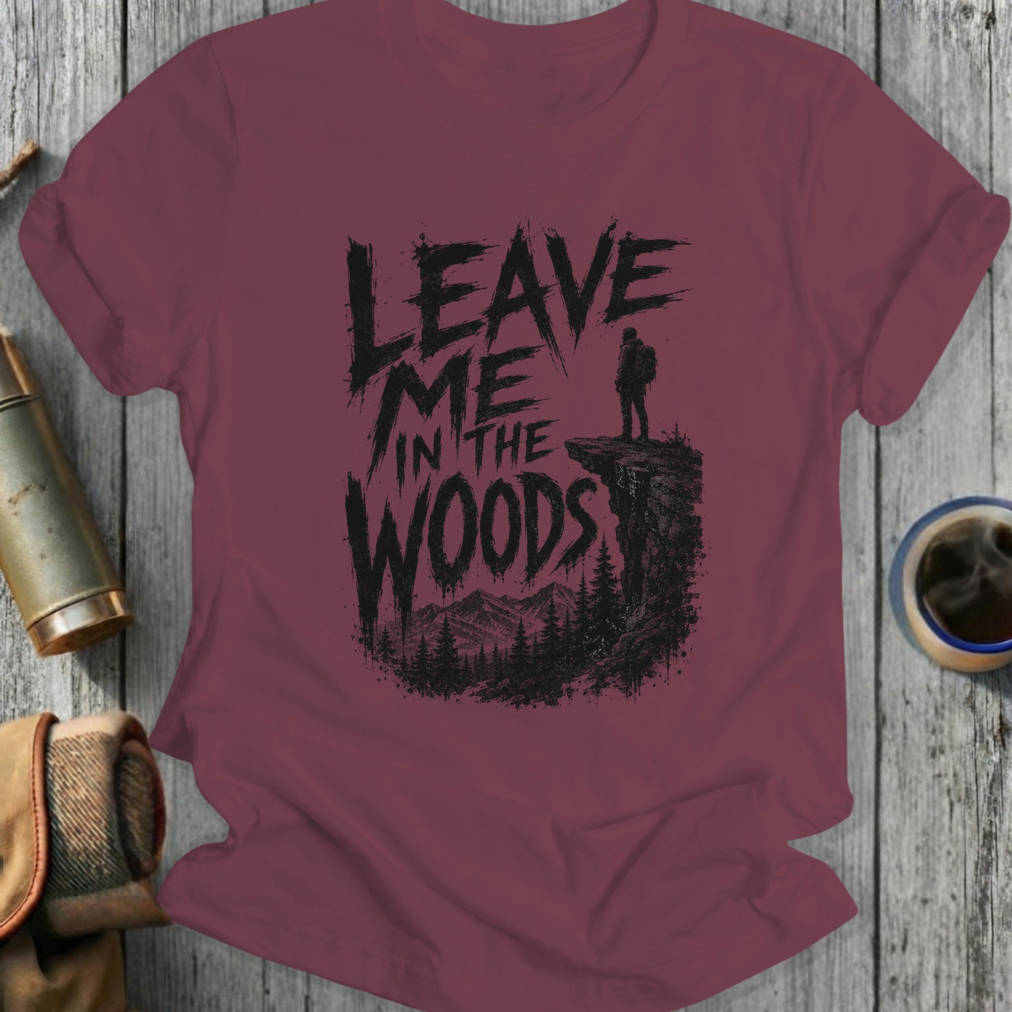 Maroon t-shirt with "Leave Me In The Woods" text and a hiker.