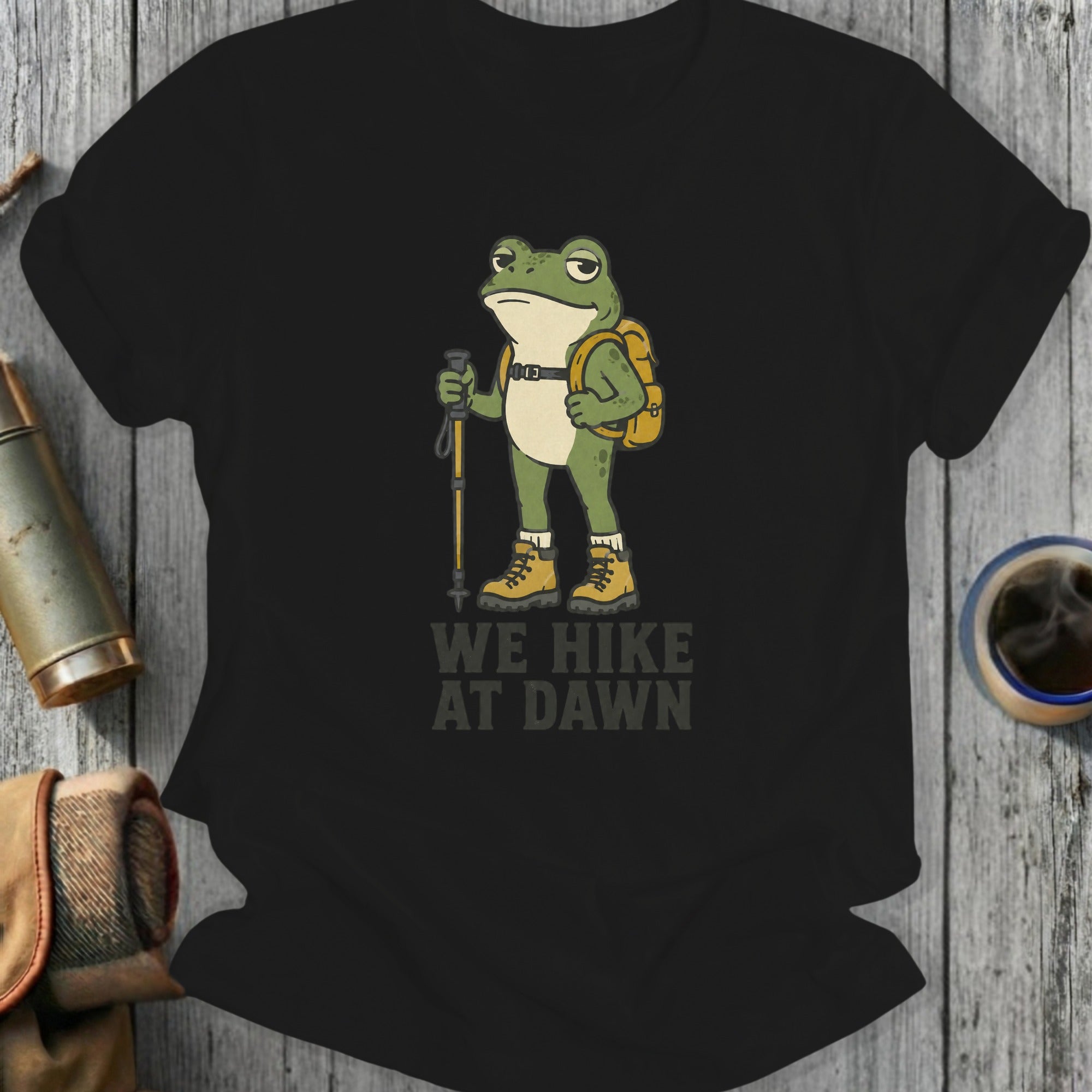 Black t-shirt with frog hiker graphic and text "WE HIKE AT DAWN".