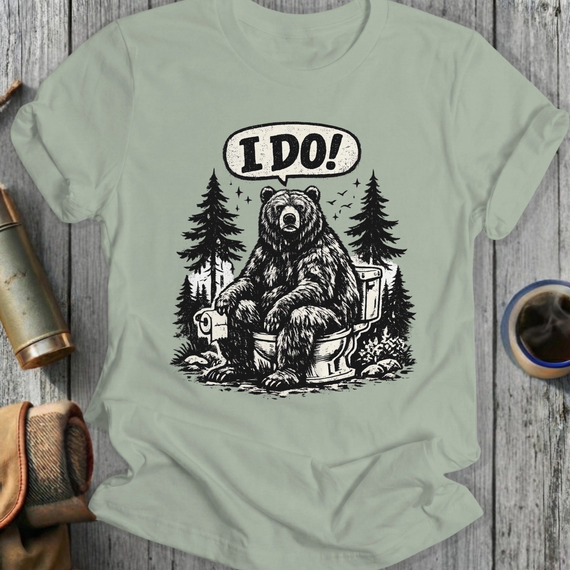 Bear sitting on a toilet with "I DO!" speech bubble in a forest.