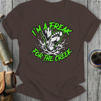 Brown t-shirt with "I'm a freak for the creek" text and Bigfoot foot splashing water.