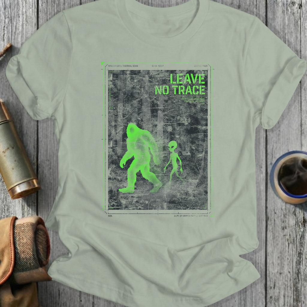 Green Bigfoot and alien figures on a distressed background with "LEAVE NO TRACE" text.