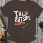Brown t-shirt with "THINK OUTSIDE NO BOX REQUIRED" text and dirt path graphic.
