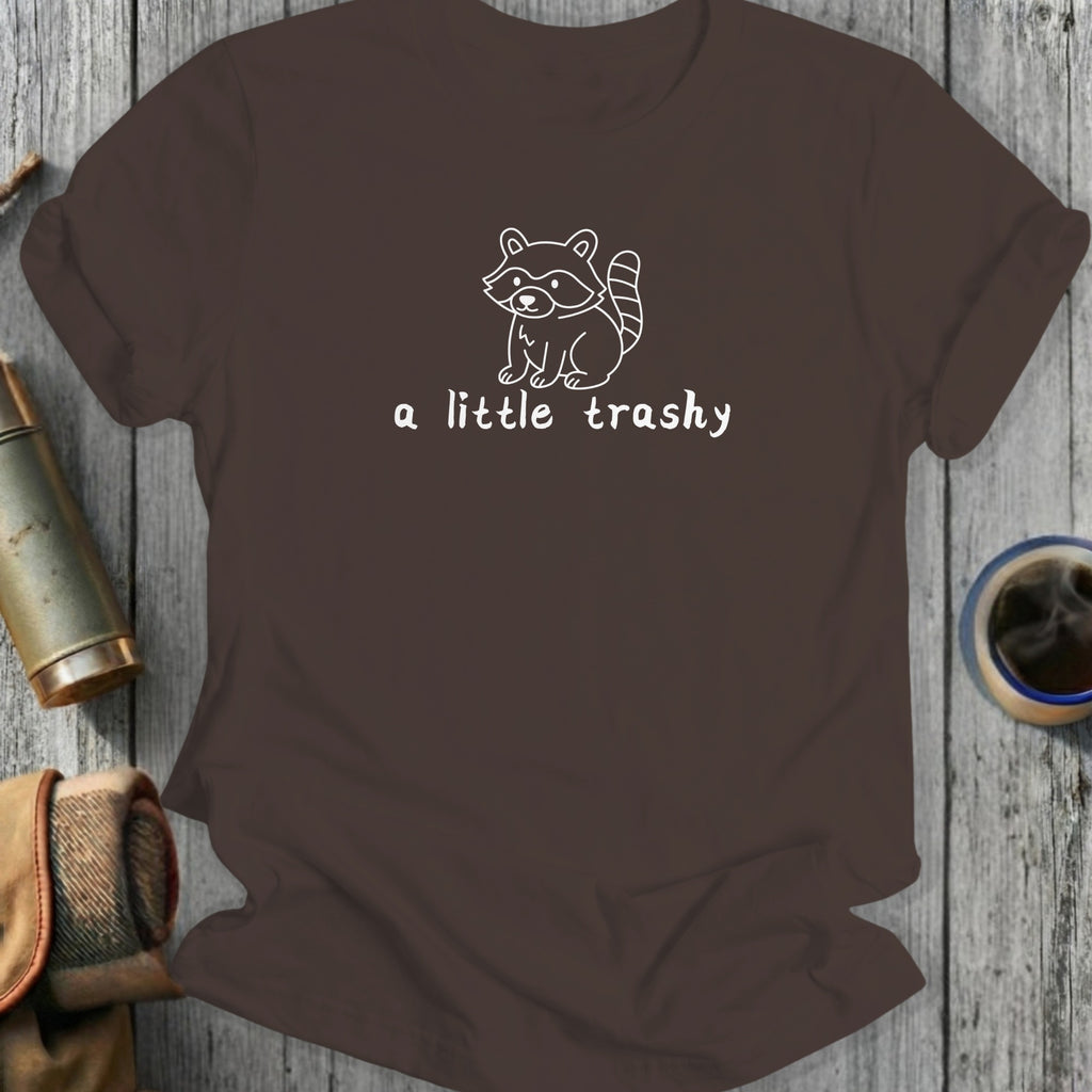 Brown t-shirt with white outline of a raccoon and text "a little trashy".