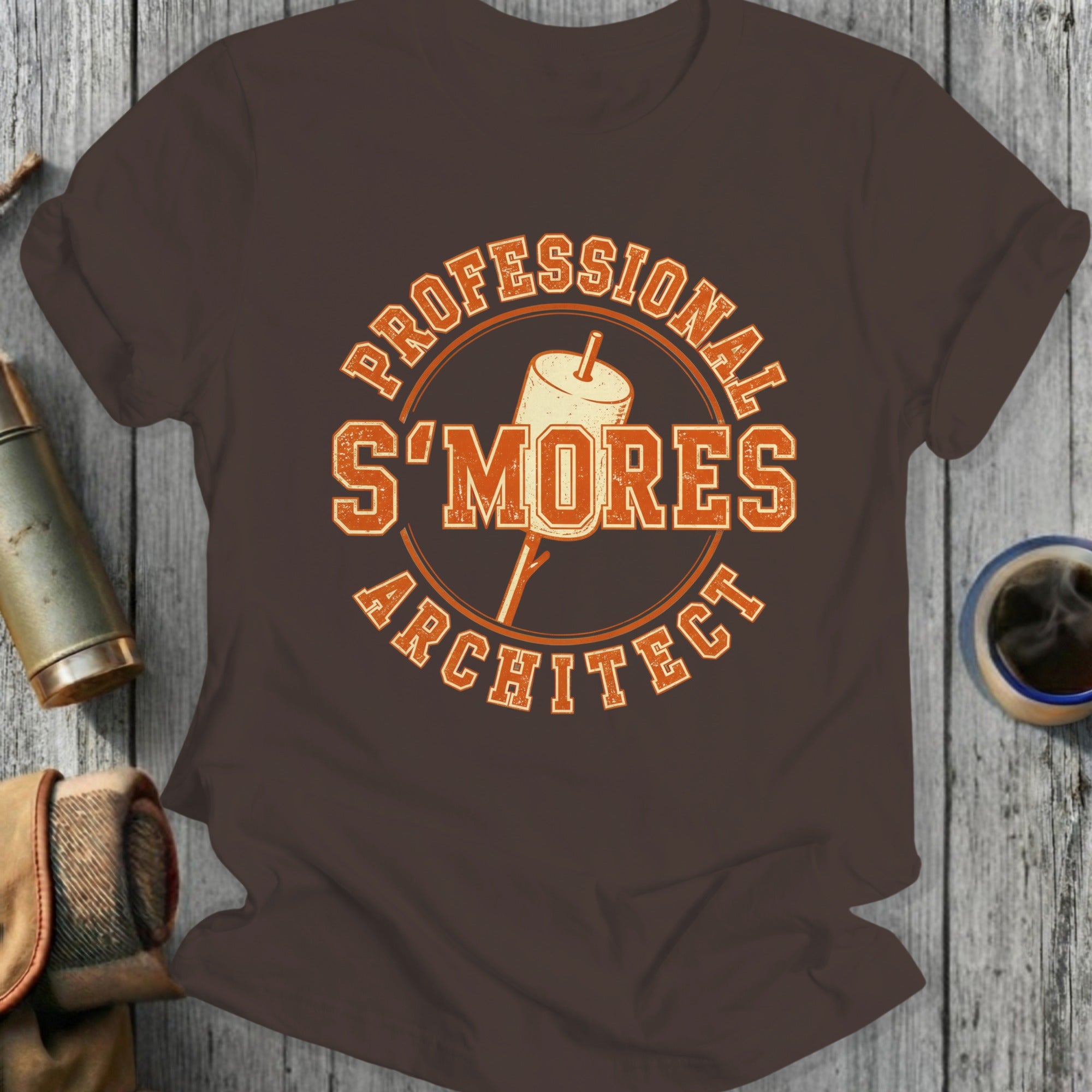 Brown t-shirt with "Professional S'Mores Architect" text and marshmallow on stick.