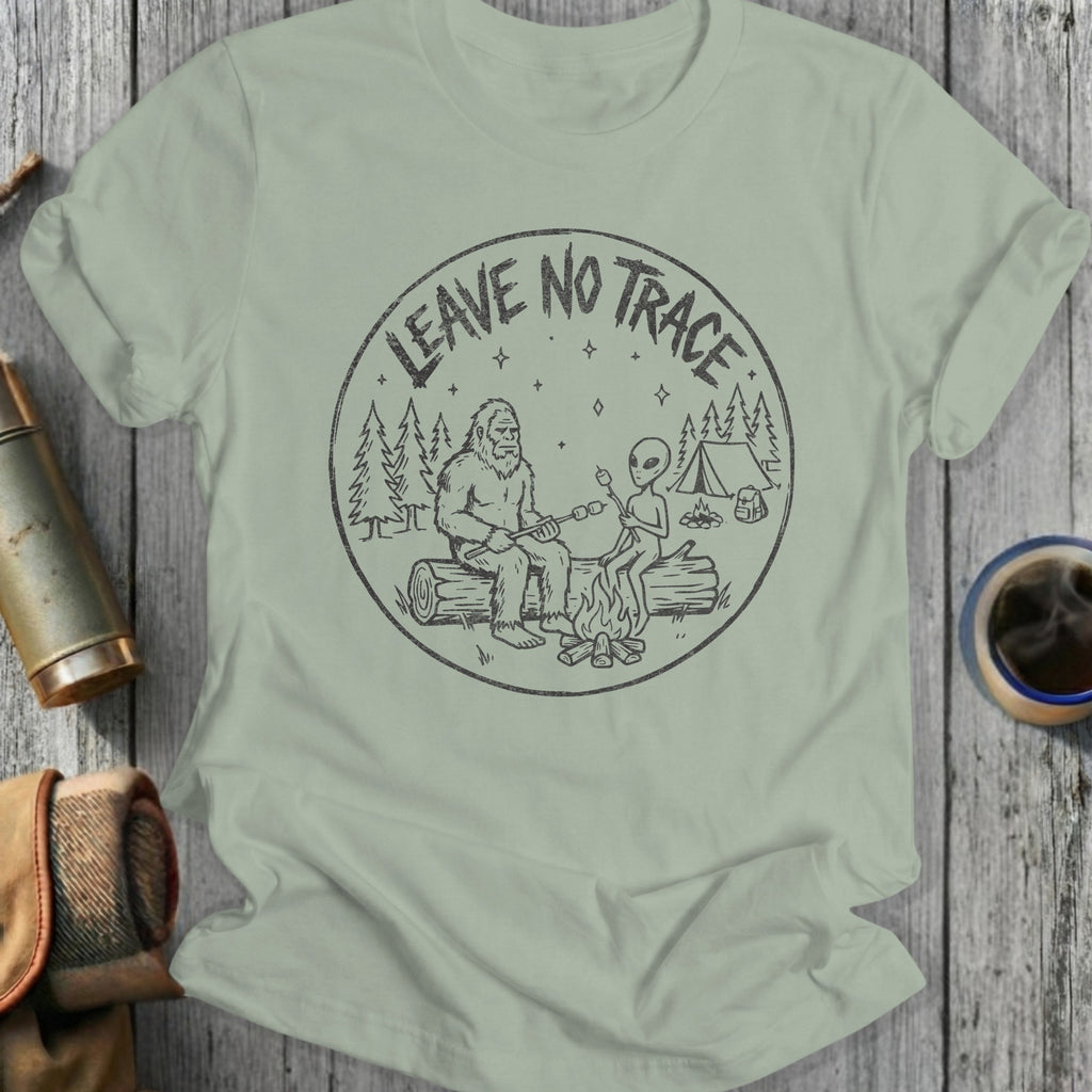 T-shirt graphic with Bigfoot and alien sitting by campfire, "Leave No Trace" text.