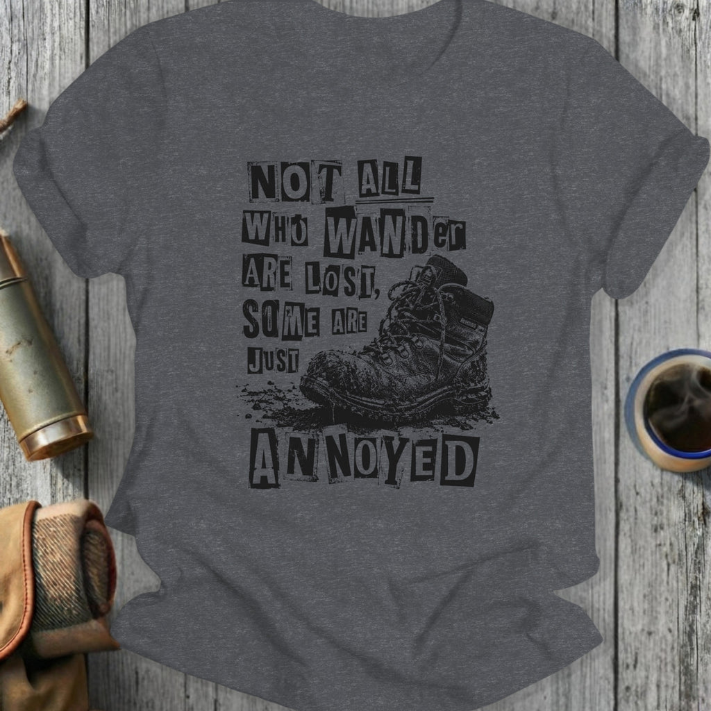 T-shirt with text "Not all who wander are lost, some are just annoyed" over a boot.