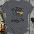 T-shirt with owl wearing headlamp and watch and text "Wilderness legend in bed by 9".