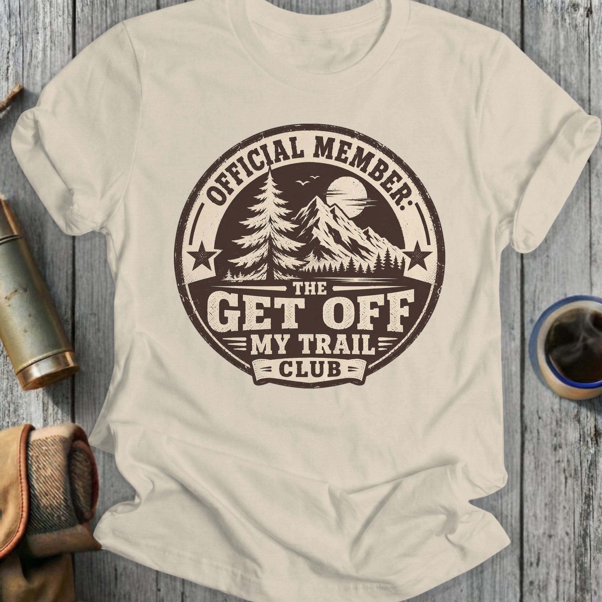 Official Member The Get Off My Trail Club emblem with trees and mountains.