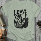 T-shirt with "Leave Me In The Woods" text and hiker silhouette on cliff.