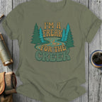 Green t-shirt with "I'm a freak for the creek" graphic and trees.