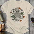 T-shirt with wood grain circle, ferns, mushrooms, poppies, and a bee.