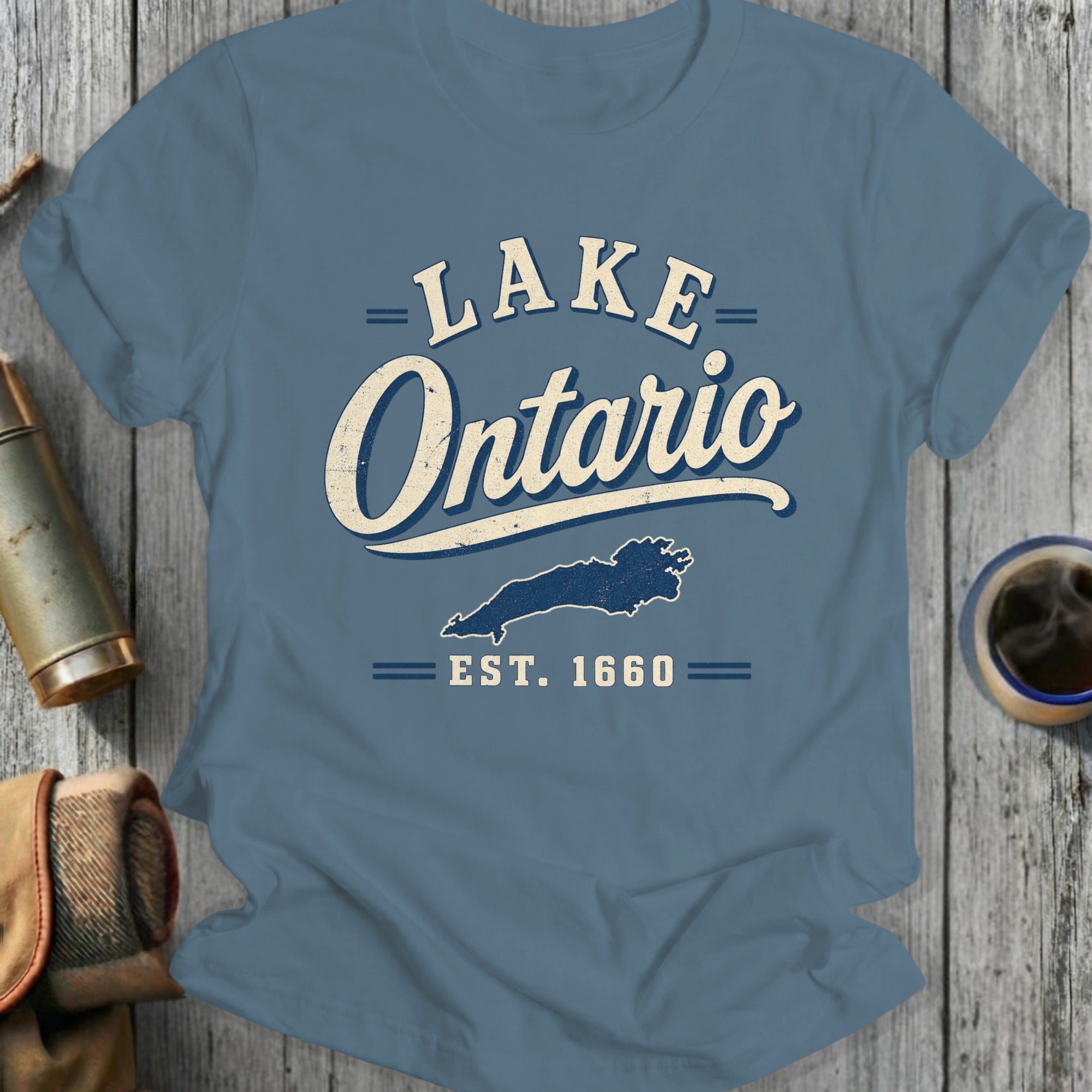 Blue t-shirt with "Lake Ontario Est. 1660" text and a map outline.