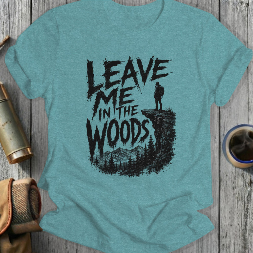 T-shirt with "Leave Me in the Woods" text over a hiker on a cliff.
