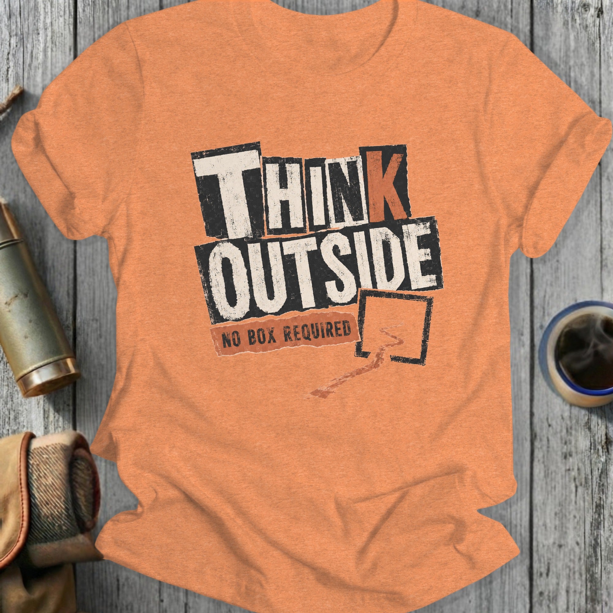 Orange t-shirt with "THINK OUTSIDE NO BOX REQUIRED" text design.