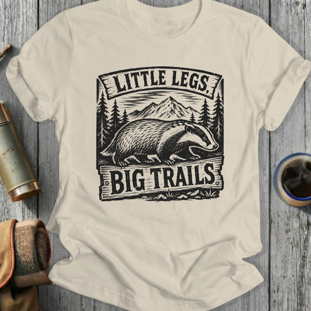 Cream t-shirt with badger, mountains, and "Little Legs Big Trails" text.
