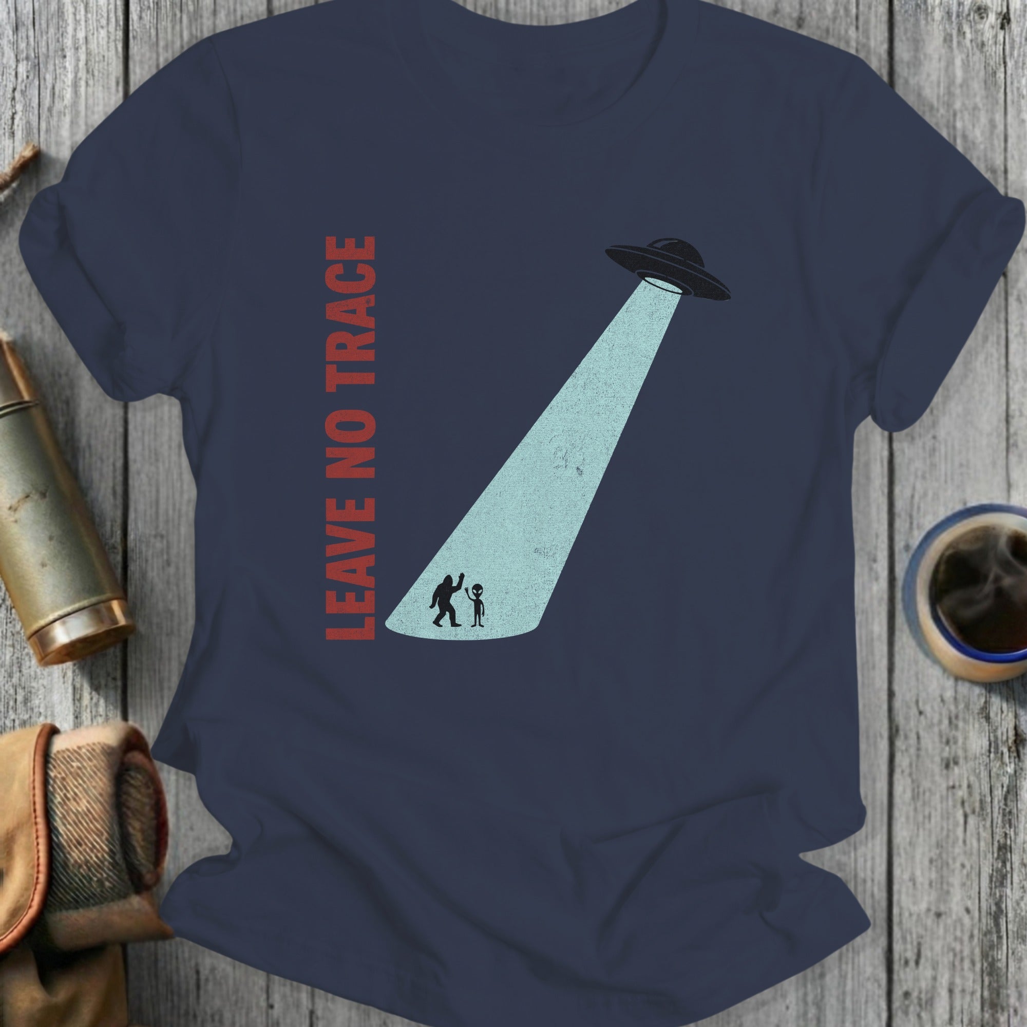 Navy t-shirt with "LEAVE NO TRACE" text and Bigfoot and alien under UFO beam.