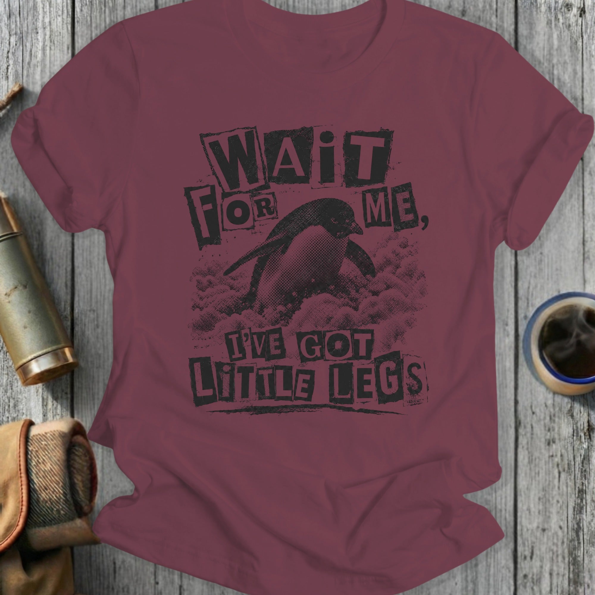 Maroon t-shirt with a distressed graphic of a penguin and text "Wait for me, I've got little legs."