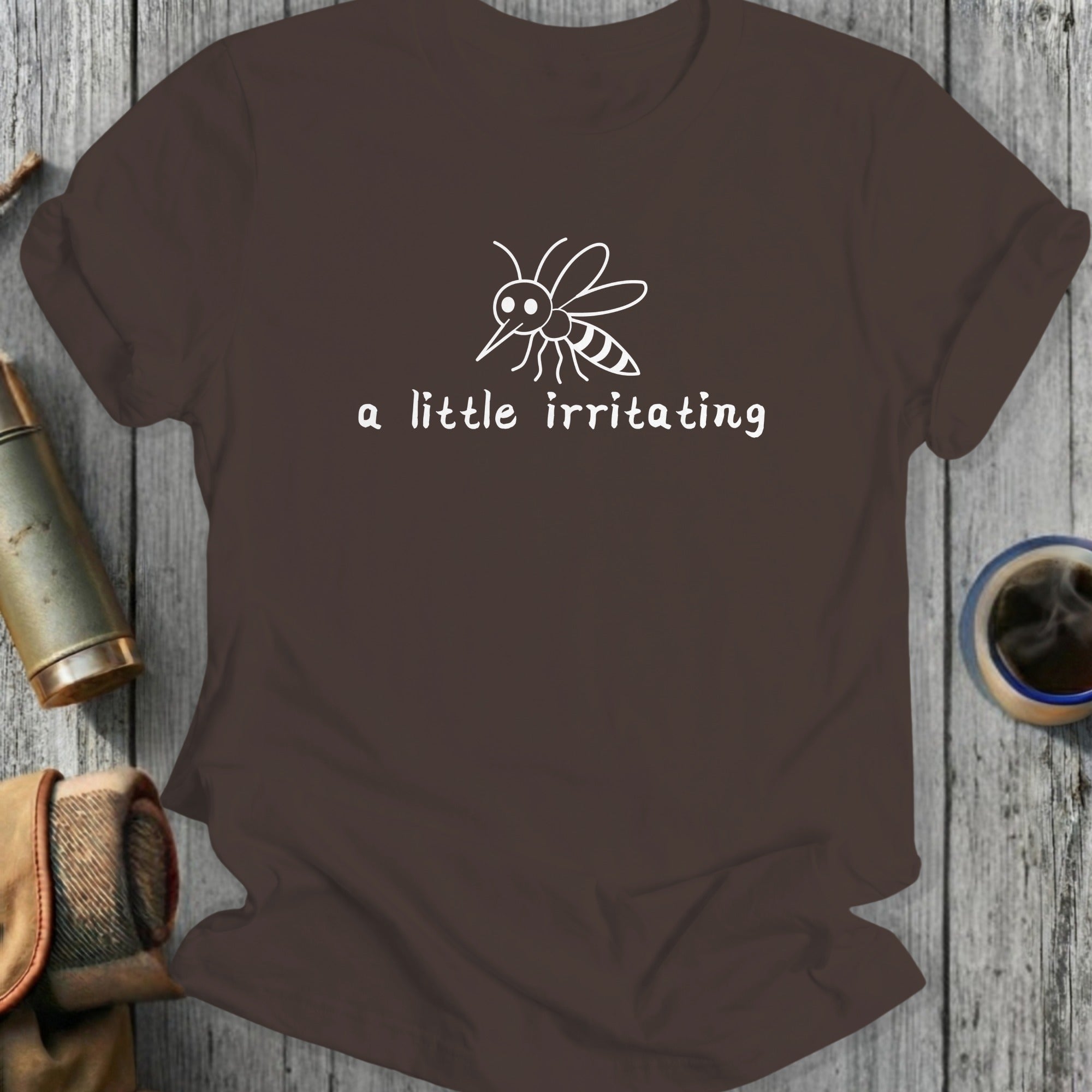 Brown t-shirt with white mosquito graphic and "a little irritating" text.