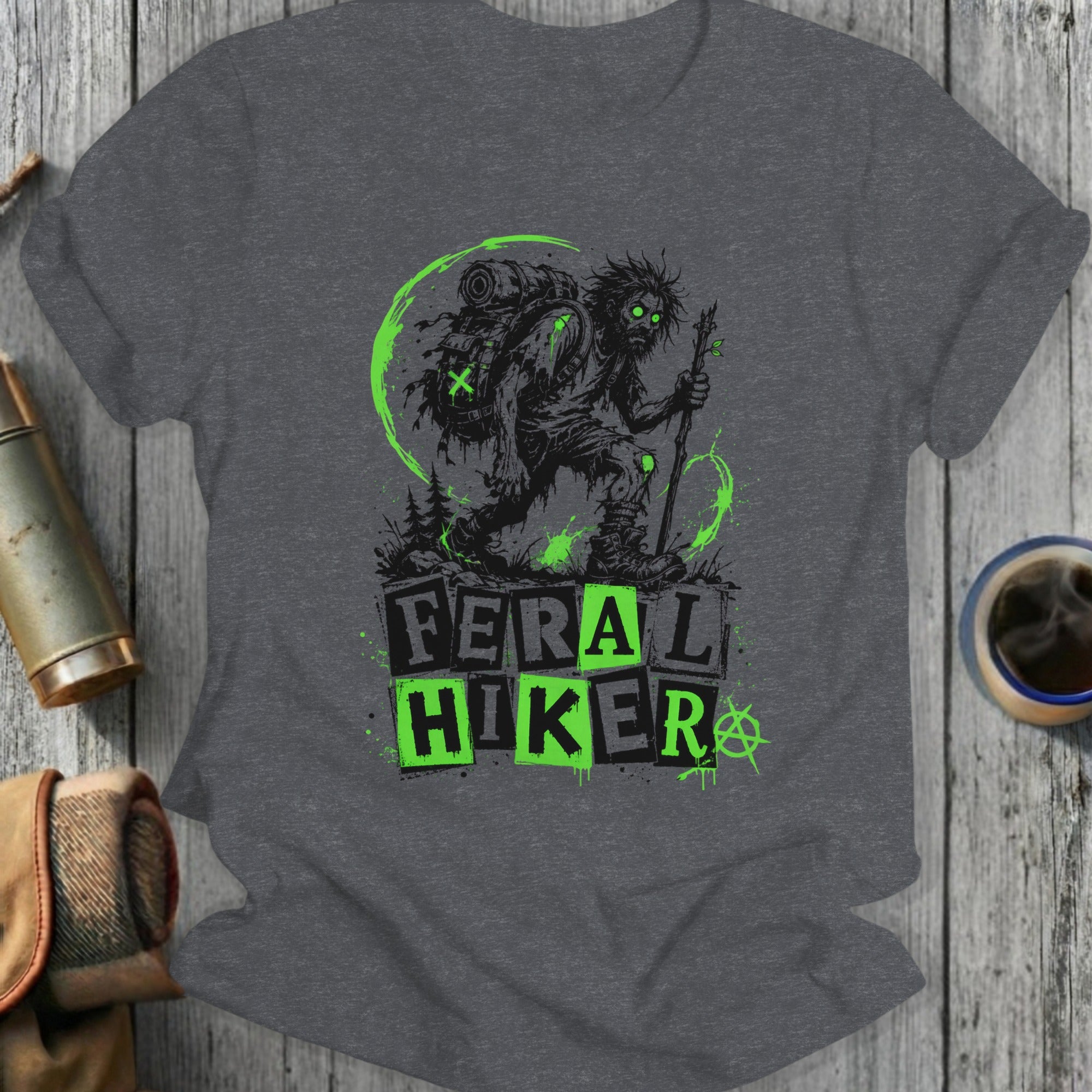Feral Hiker graphic with a zombie-like figure on a charcoal t-shirt.