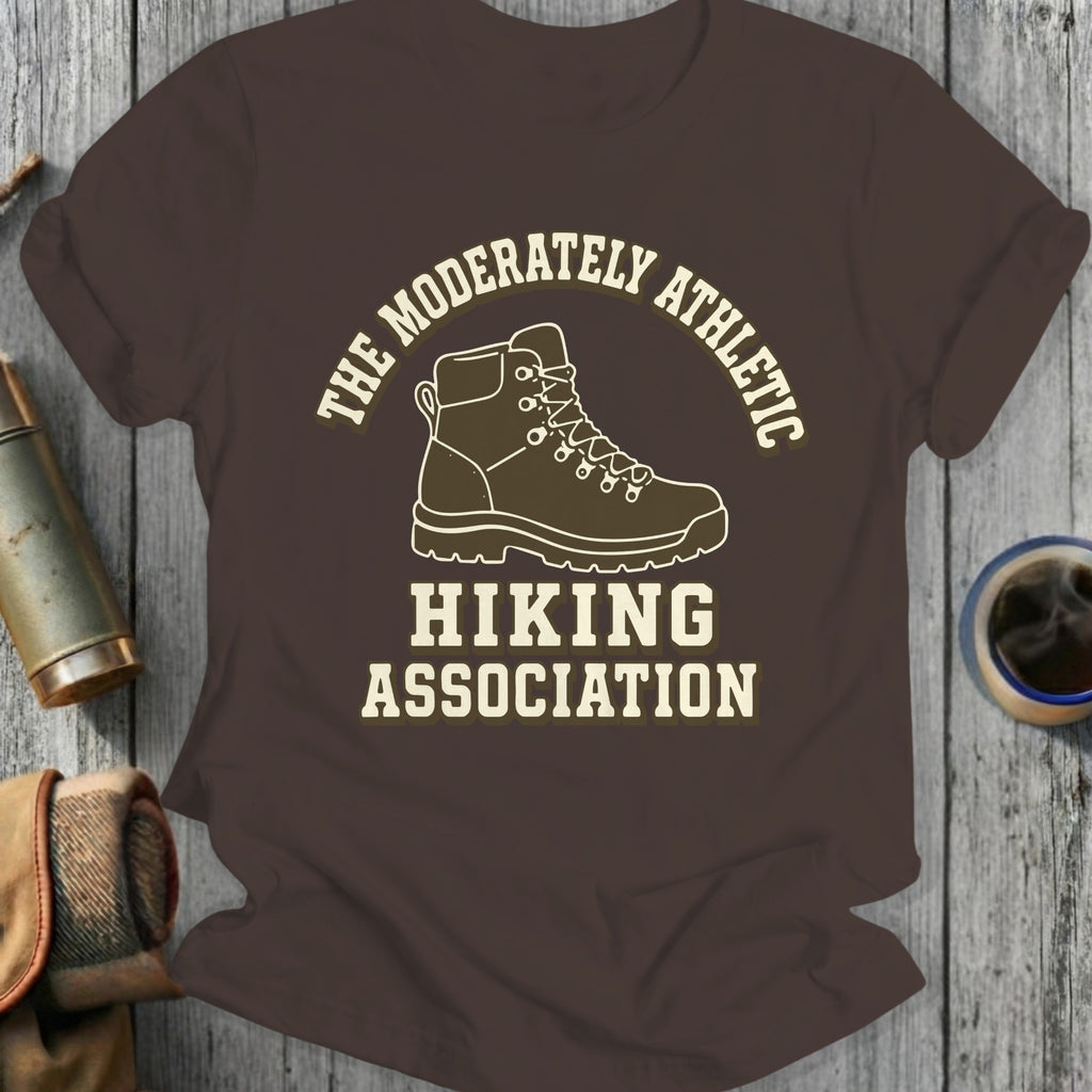 Brown t-shirt with "The Moderately Athletic Hiking Association" text and hiking boot graphic.