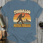 Bigfoot silhouette with peace sign and mountains, text "TOODALOO MUTHA FUCKAAS".